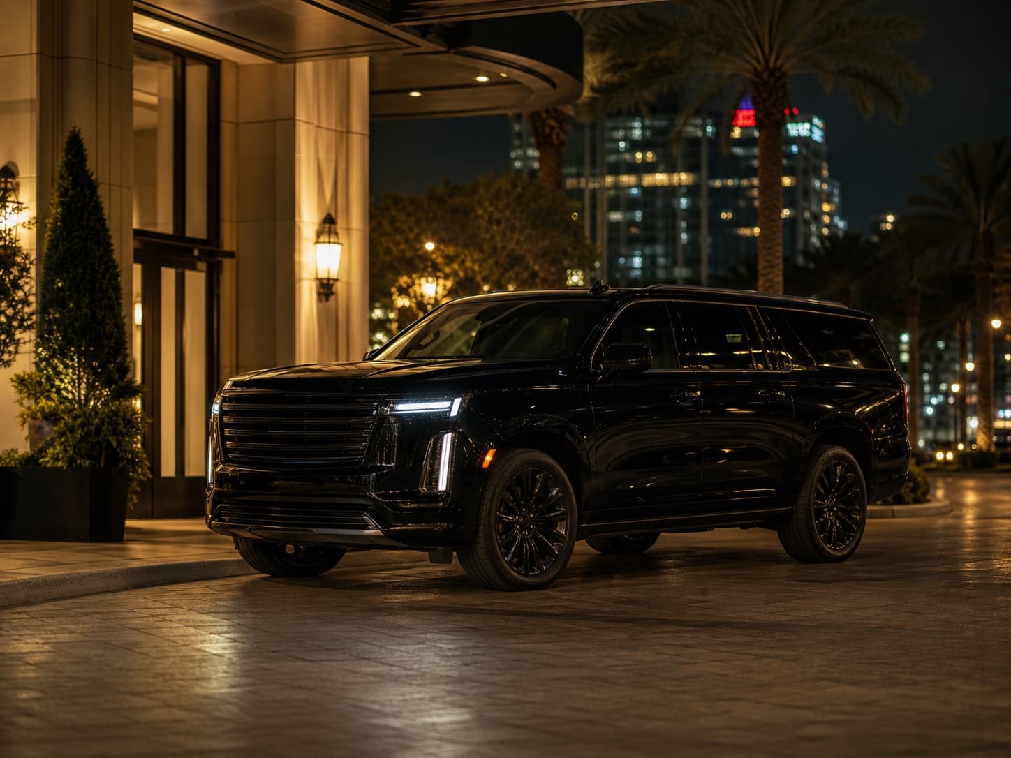 A polished black SUV waiting beneath warm lights outside an Atlanta event venue.